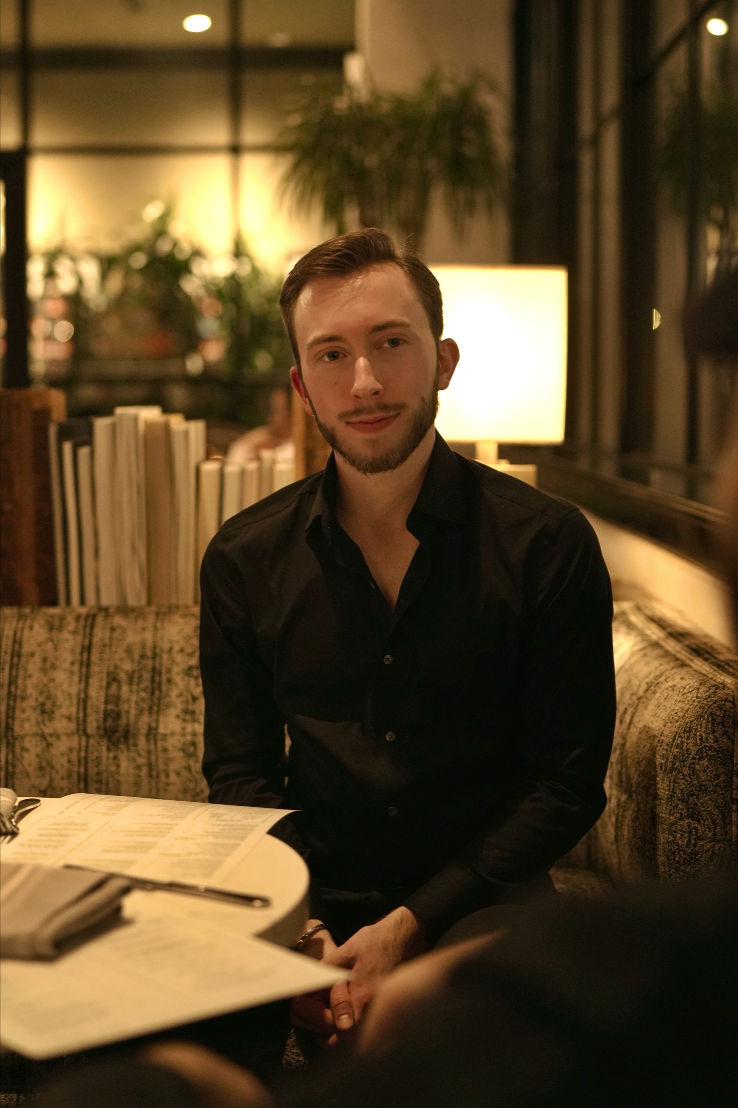 Brian Oliver seated in a warmly lit restaurant